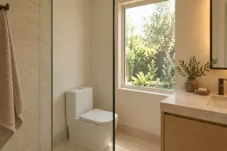 Fulton House — ADU bathroom · daylight, stone and integrated storage