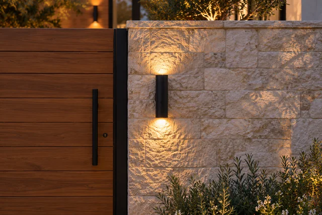 Roxbury Residence — Exterior · Stone wall evening light